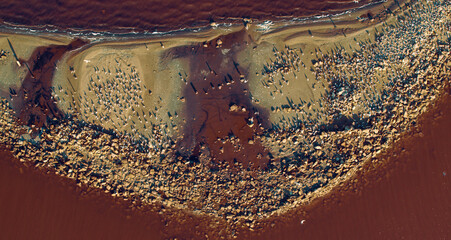 Drone view salt island in pink water surface. Top view salt coastline birds