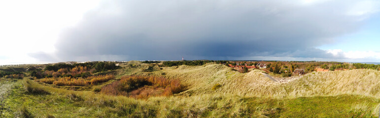 Obraz premium Dunes and Lighthouse at the Beach of Amrum, Germany, Europe