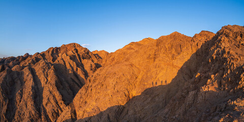 panorama in mountain range at sinai egypt similar to Martian landscapes with shadows of people