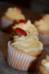 Tasty cupcakes with buttercream and strawberry. Home made cupcakes with vanilla cream 