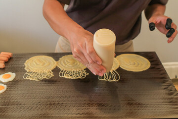 Thai dessert (Khanom Tokyo), cooking thin flat pancake filled with sweet custard cream, egg, mince pork, sausage