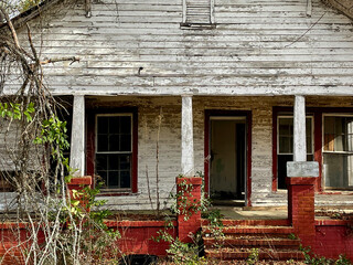 Old creepy scary abandoned building front porch red steps