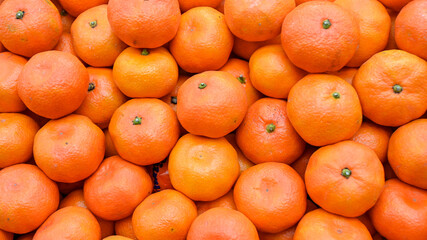 Fresh mandarins on fruit market, close up. Boxes full of ripe mandarin oranges for sale in...