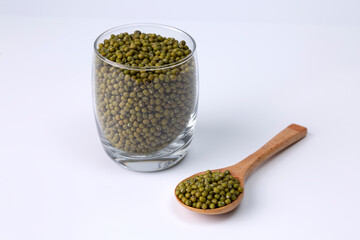 mung bean in glass and wood spoon on white background studio shot