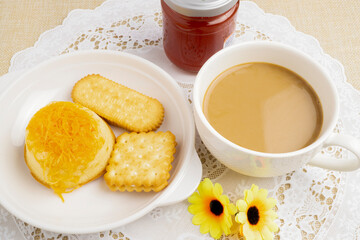 Golden Egg Yolk Threads Cake, Thai sweets, with biscuits served on white dish with hot coffee, good for morning meal