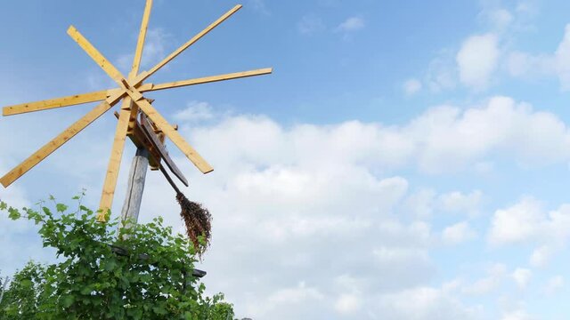 Styrian Klapotetz (wind wheel) during summer - clouds passing by in the background - timelapse.