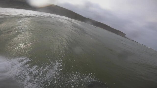surfing in Coxos in Ericeira on a cloudy day