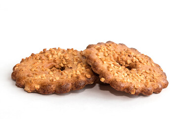Delicious shortcrust pastry biscuits with peanut peanut topping on white isolated background. 