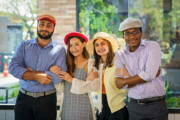 multiracial tourist group posing for photograph together during having tour around city in summer