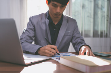 businessman signing documents at work