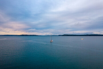 Sailboat on the Puget Sound at sunset  - obrazy, fototapety, plakaty