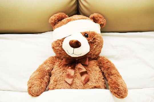 Oso de peluche caf&eacute; en recuperaci&oacute;n, vendaje en la cabeza. Concepto medico, vista superior.