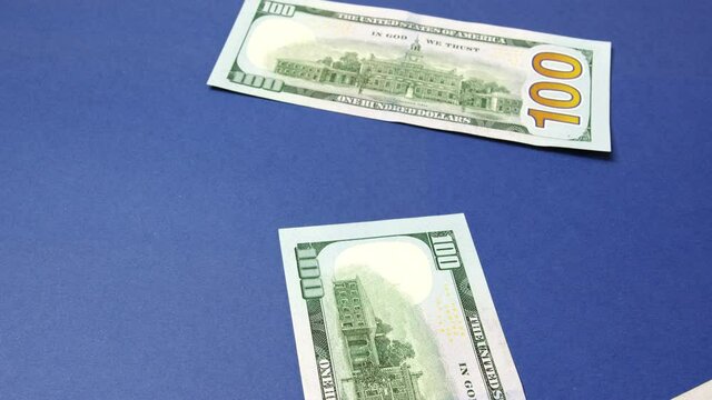 Falling dollar bills. The concept of investment, success, financial prospects or career growth.The video can be used in selling, expenses, usd, stack, closeup, accounting, growth, bills, buy, usa, deb