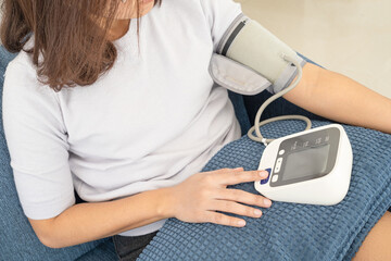 woman check blood pressure monitor and heart rate monitor with digital pressure gauge. Health care and Medical concept