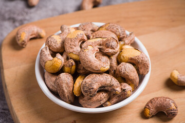 close up of cashew nuts on wooden background