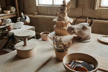 Close-up of group of ceramic sculptures on the table in workshop