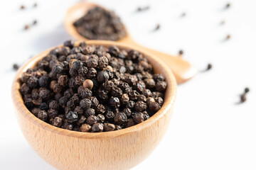 black pepper in a wooden cup
