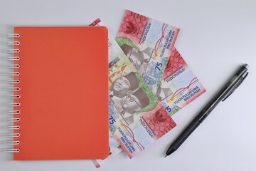 Rupiah the official currency of Indonesia. Business and finance concept. Uang 75000 Rupiah. Bank...