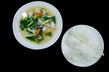 Die cut of Fried Noodle with seafood in Gravy Sauce and crispy noodle on black background.
