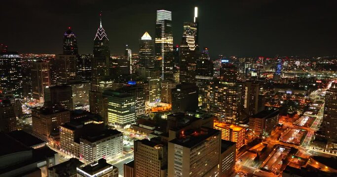 Aerial of dark sky with cityscape in USA. Dramatic powerful drone clip with traffic on highway. 