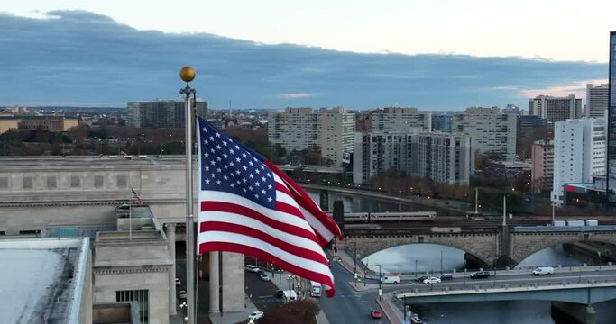 American flag in urban American city. Dawn dusk low light shot. Lifestyle in USA.