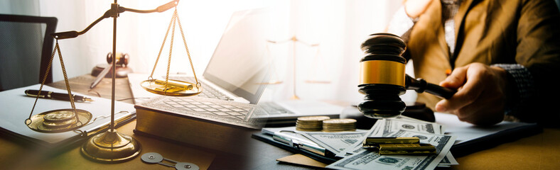 Justice and Law concept. Legal counsel presents to the client a signed contract with gavel and...