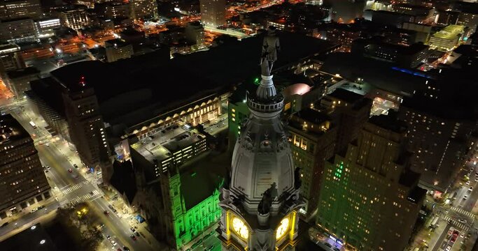 Orbit of City Hall in Philadelphia at night. Lights of traffic and buildings below. Drone establishing shot.