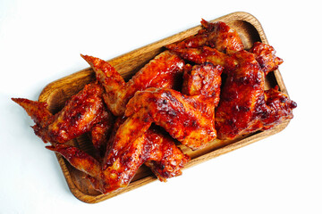 Grilled or roasted spicy chicken wings with bbq sauce isolated white 