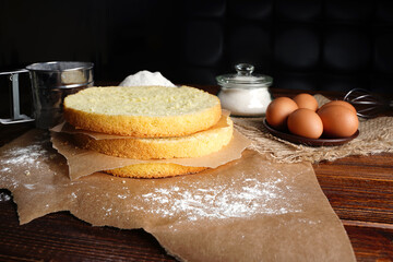 Cutting the biscuit into layers. Slicing sponge cake at home in the kitchen.