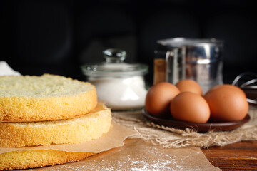 Cutting the biscuit into layers. Slicing sponge cake at home in the kitchen.