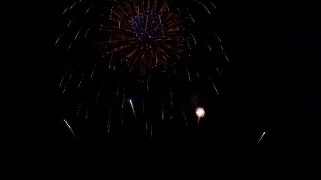 Smoke and fire fill the night sky during a fireworks display.