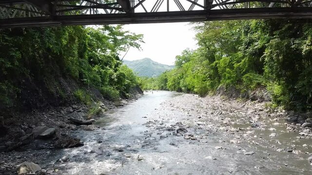 flying underneath a bridge in Colombia.