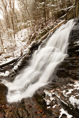 Fototapeta premium Carpenter Falls long exposure, with snow in Granby, Connecticut.