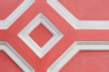 Red and white geometric wall decoration, close up photo