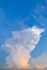 Fototapeta na wymiar Blue sky with white cumulus clouds in evening. Natural vertical photo
