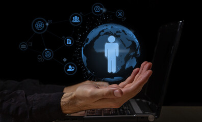 Business management on the Internet. Business leadership concept. Management and selection of personnel. The hand holds the projection of the planet and the person in it