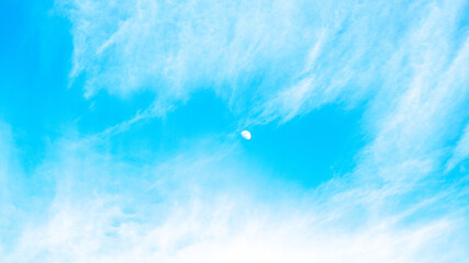 Half moon in blue sky in the afternoon