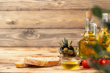 Italian ciabatta bread with olive oil on wooden background