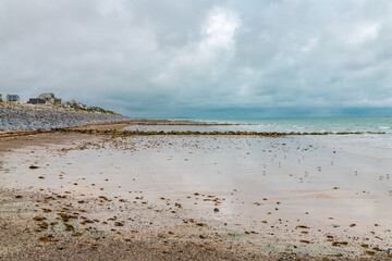 Beautiful beach at Agon-Coutainville in Normandy, with houses on the coast
