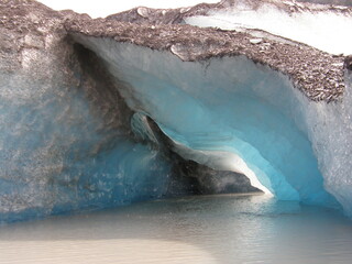 the   opening to a blue Ice cave at valdez glacier lake in valdez glacier, near valdez, alaska
