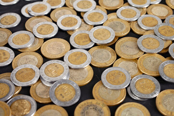 mexican peso coins on a table background