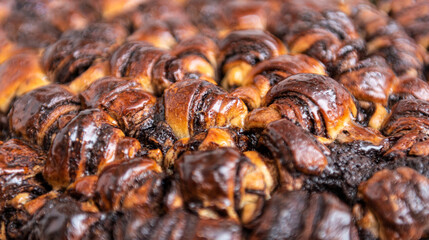 Rugelach (shortbread cookies) with cocoa and brown sugar. Many small croissants in a cake tray and rich chocolate filling
