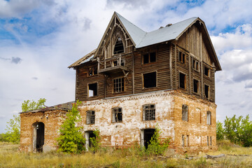 Fototapeta premium The building of an old abandoned mill in the countryside. The picture was taken in the village of Pervokrasnoe, in the Orenburg region