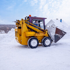 snow removal by a mini tractor in a locality