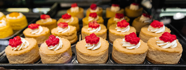 Cake displayed in shop window of confectionery or cafe. Fresh pastries on display on a confectionery stall