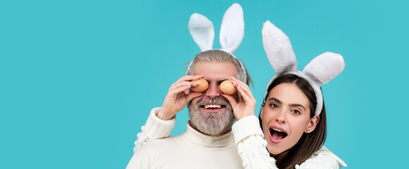 Easter couple. Happy smiling Couple with Easter eggs. Banner with funny bunny couple, copy space.