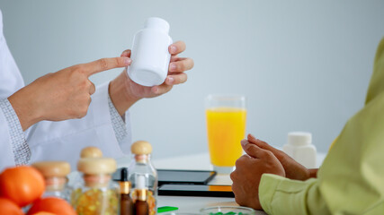 Professional pharmacist explain dose benefit and drink instruction on medicine bottle to patient for disease treatment and health therapy