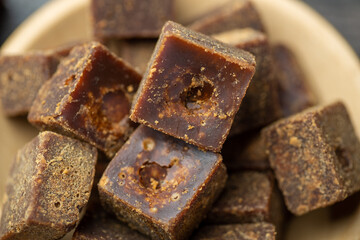 Lumpy brown sugar on a white background