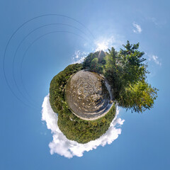 green tiny planet in blue sky with beautiful clouds. Transformation of spherical panorama 360...