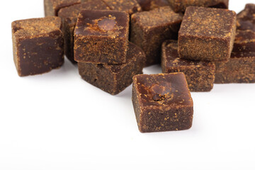 Lumpy brown sugar on a white background
